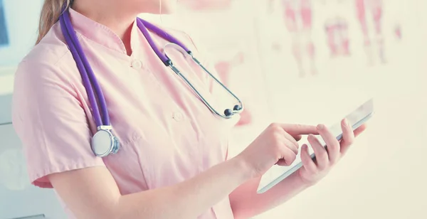 Doctor woman checking medical data on tablet pc