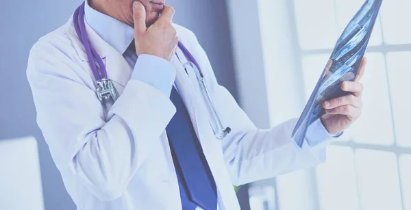 Male doctor writes notes on the clipboard in the hospital