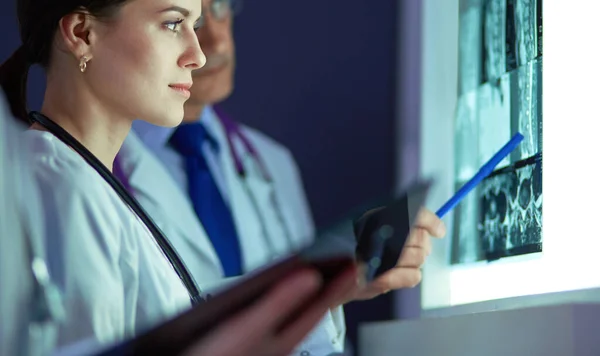 Groep artsen die röntgenfoto 's in een kliniek onderzoeken, denken aan een diagnose — Stockfoto