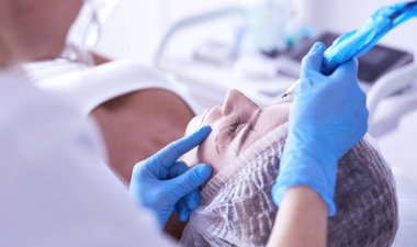 Kaşlar için kalıcı makyaj. Güzellik salonunda kalın kaşlı güzel bir kadın..