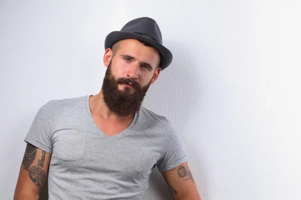 Portrait of handsome bearded man in hat standing , isolated on — Stock Photo, Image