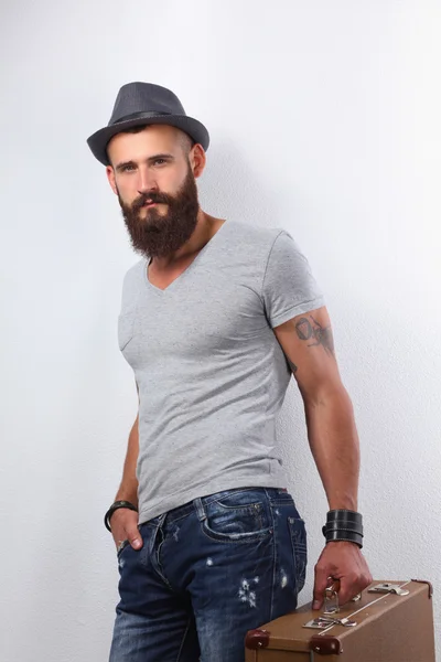 Portrait of handsome bearded man in hat standing with bad, isol — Stock Photo, Image