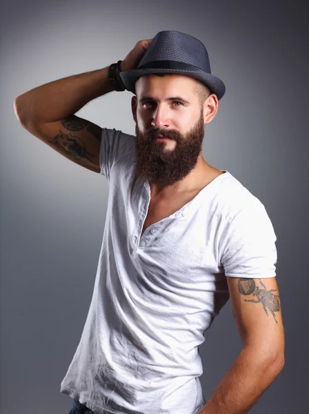 Portrait of handsome bearded man in hat standing , isolated on — Stock Photo, Image