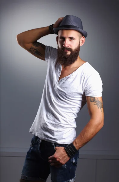 Portrait of handsome bearded man in hat standing , isolated on — Stock Photo, Image