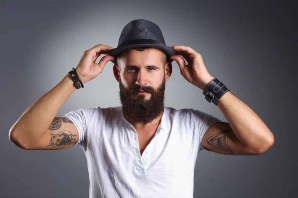 Portrait of handsome bearded man in hat standing , isolated on — Stock Photo, Image