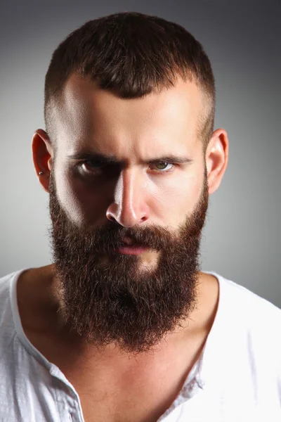 Portrait of handsome bearded man standing, isolated on grey bac — Stock Photo, Image