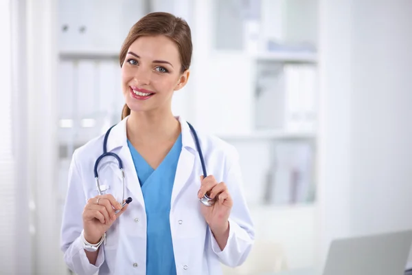 Portrait of happy successful young female doctor holding a stet — Stock Photo, Image