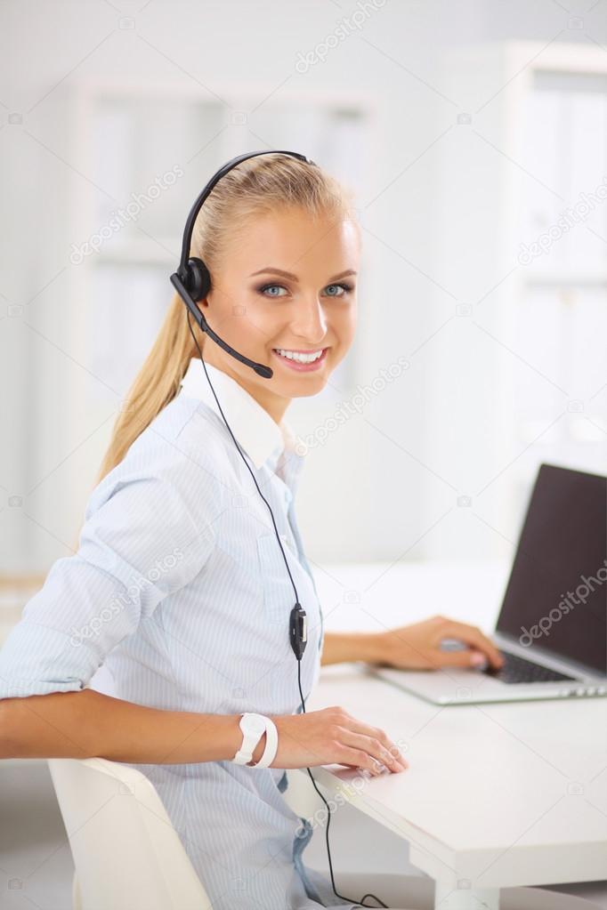 Portrait of beautiful businesswoman working at her desk with he