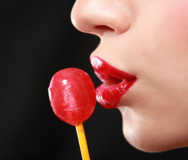 Young beautiful girl with lollipop in her mouth clipart