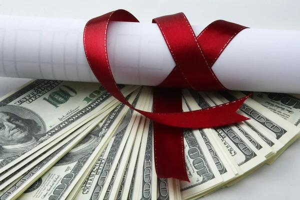 Close-up of dollars and a diploma with red ribbon — Stock Photo, Image