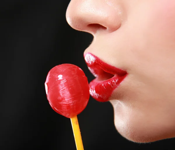 Young beautiful girl with lollipop in her mouth — Stock Photo, Image