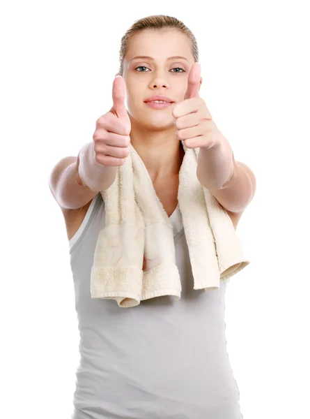 Young sportive girl with towel showing ok, isolated on white background — Stock Photo, Image
