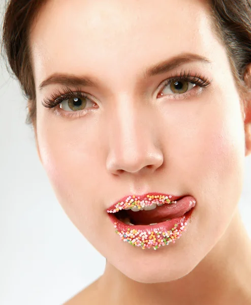 Woman lips with multicolored pearls — Stock Photo, Image