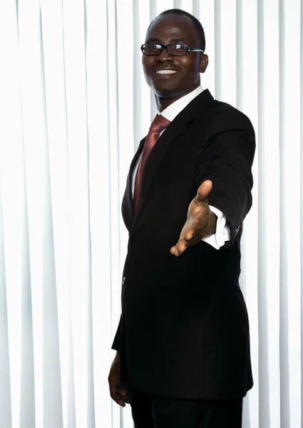 Businessman giving his hand — Stock Photo, Image