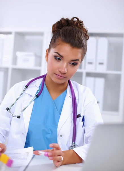 Woman researcher is surrounded by medical vials and flasks, isolated on white background — Stock Photo, Image