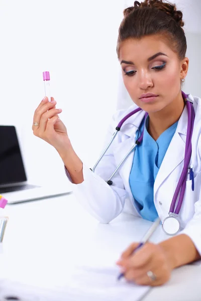 Woman researcher is surrounded by medical vials and flasks, isolated on white background — Stock Photo, Image