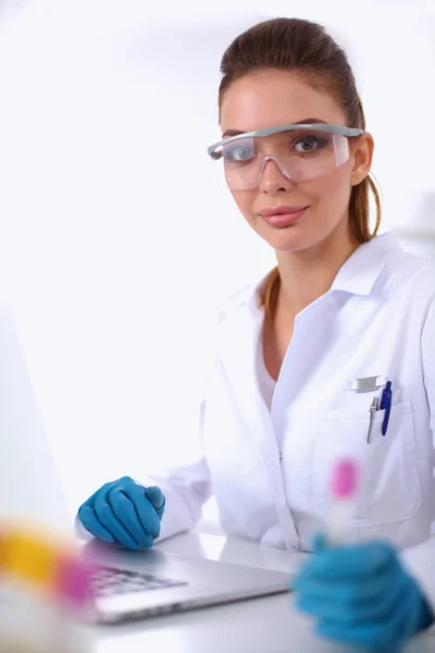 Woman researcher is surrounded by medical vials and flasks, isolated on white background — Stock Photo, Image