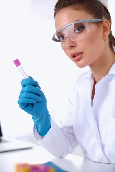 Woman researcher is surrounded by medical vials and flasks, isolated on white background — Stock Photo, Image