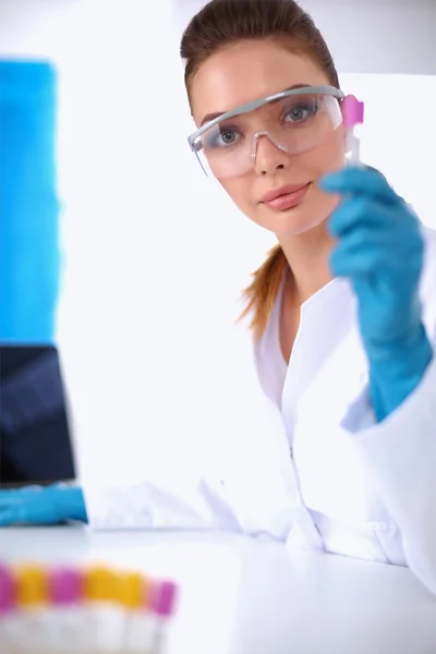 Woman researcher is surrounded by medical vials and flasks, isolated on white background — Stock Photo, Image