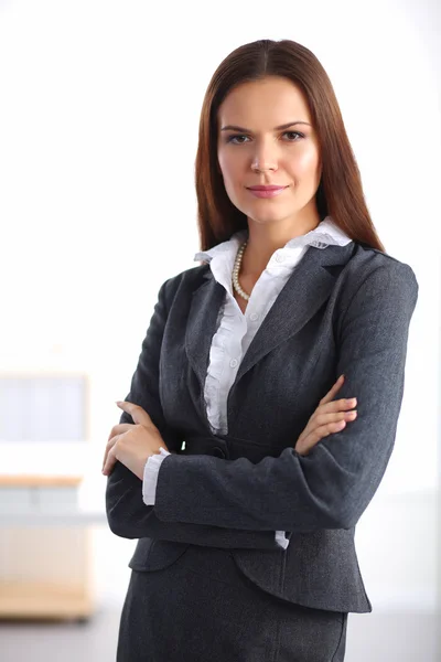 Portrait of business woman standing with crossed arms in office Royalty Free Stock Images