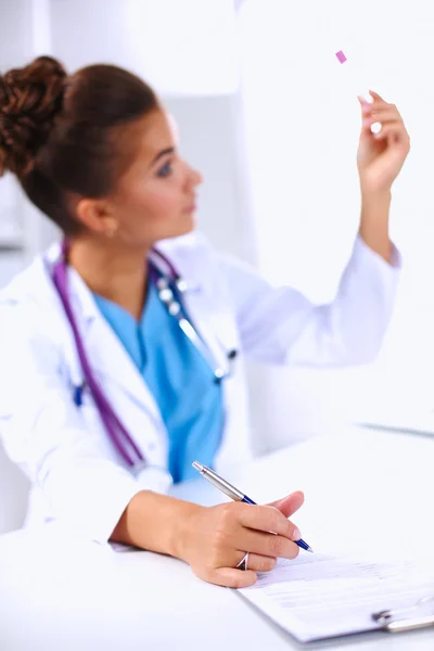 Woman researcher is surrounded by medical vials and flasks, iso — Stock Photo, Image