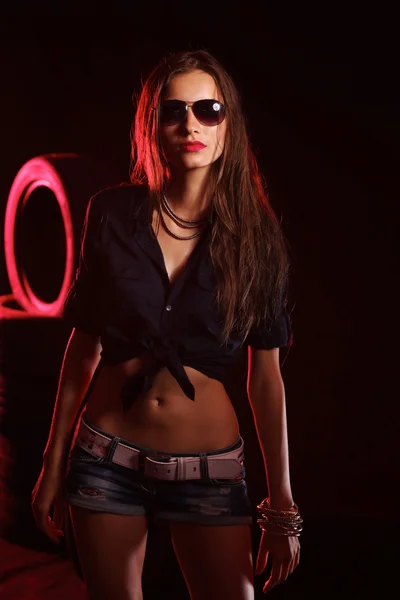 Portrait of young woman standing in the old garage. isolated on — Stock Photo, Image