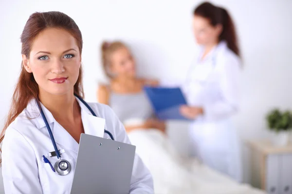 Portrait of woman doctor at hospital with folder — Stock Photo, Image