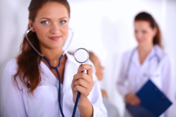 Portrait of young woman doctor with white coat standing in hosp — Stock Photo, Image