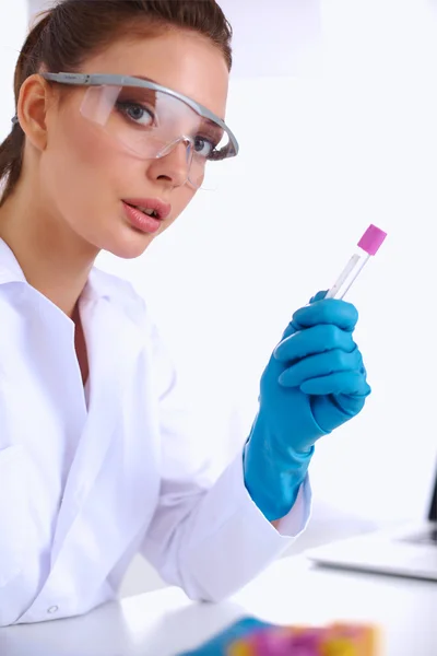 Woman researcher is surrounded by medical vials and flasks, iso — Stock Photo, Image