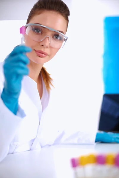 Woman researcher is surrounded by medical vials and flasks, iso — Stock Photo, Image