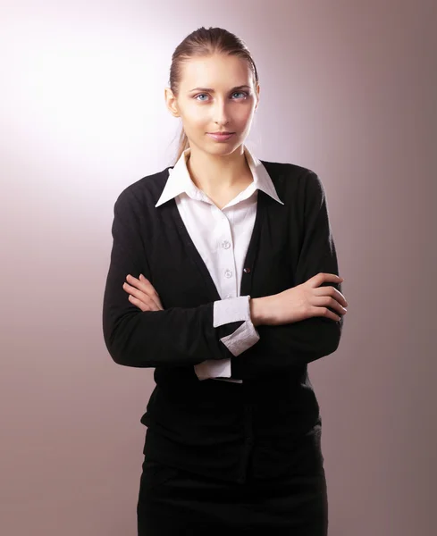 Portrait of business woman standing with folded arms Stock Photo