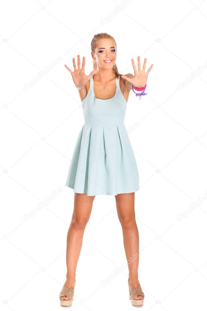 Pretty smiling girl shows ten fingers, isolated on white background