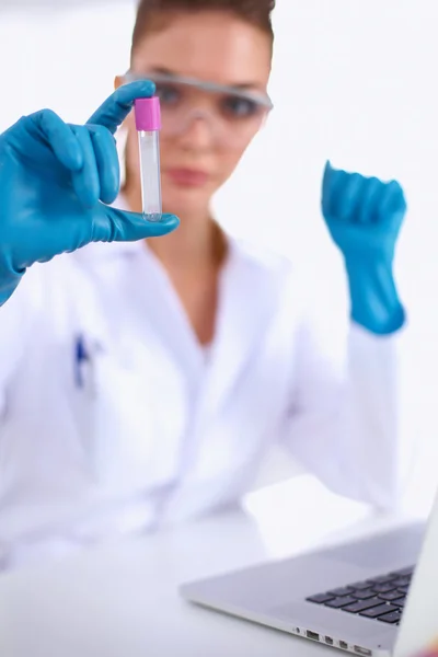 Woman researcher is surrounded by medical vials and flasks, isolated on white background — Stock Photo, Image