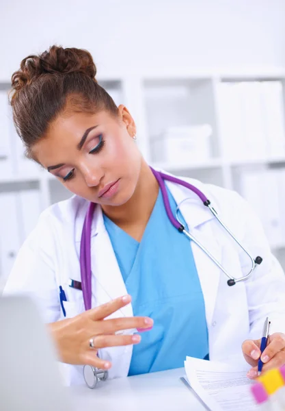 Woman researcher is surrounded by medical vials and flasks, isolated on white background — Stock Photo, Image