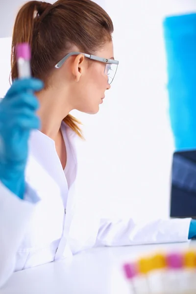 Woman researcher is surrounded by medical vials and flasks, isolated on white background — Stock Photo, Image