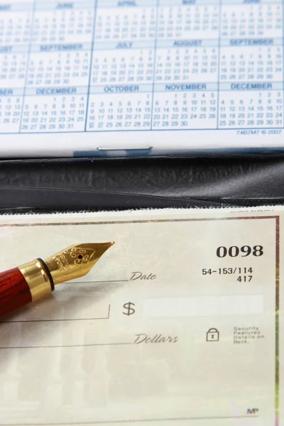 An open checkbook and a ballpen, closeup — Stock Photo, Image