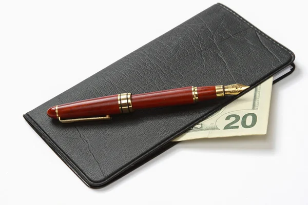 A ballpen on a closed leather checkbook — Stock Photo, Image