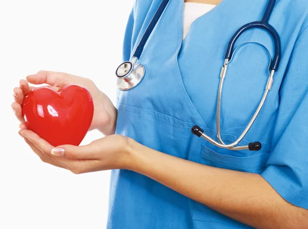 Female doctor with stethoscope holding heart, isolated on white background — Stock Photo, Image