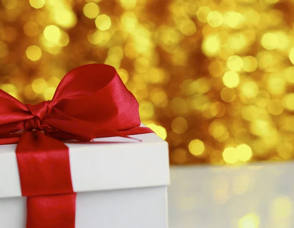 Christmas golden gift on a furry background — Stock Photo, Image