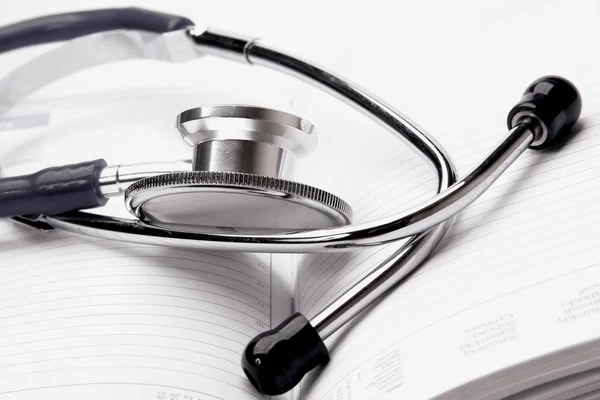 A stethoscope on an open organizer — Stock Photo, Image
