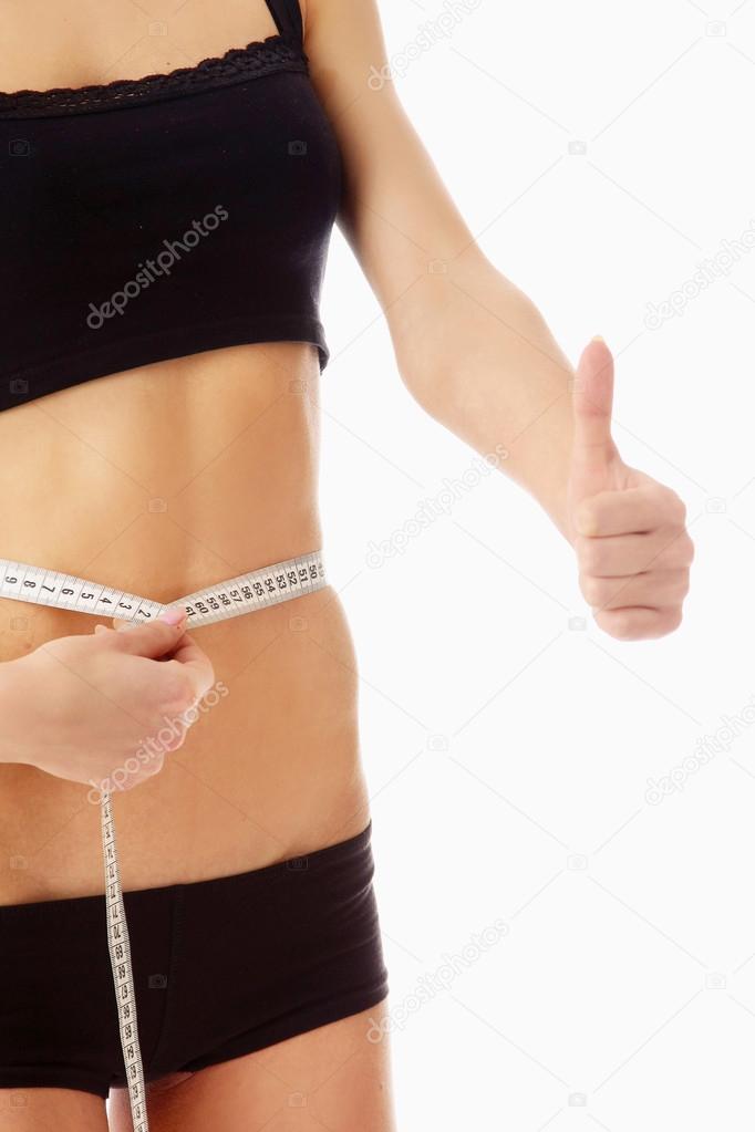 woman measure her waist belly by metre-stick and showing ok