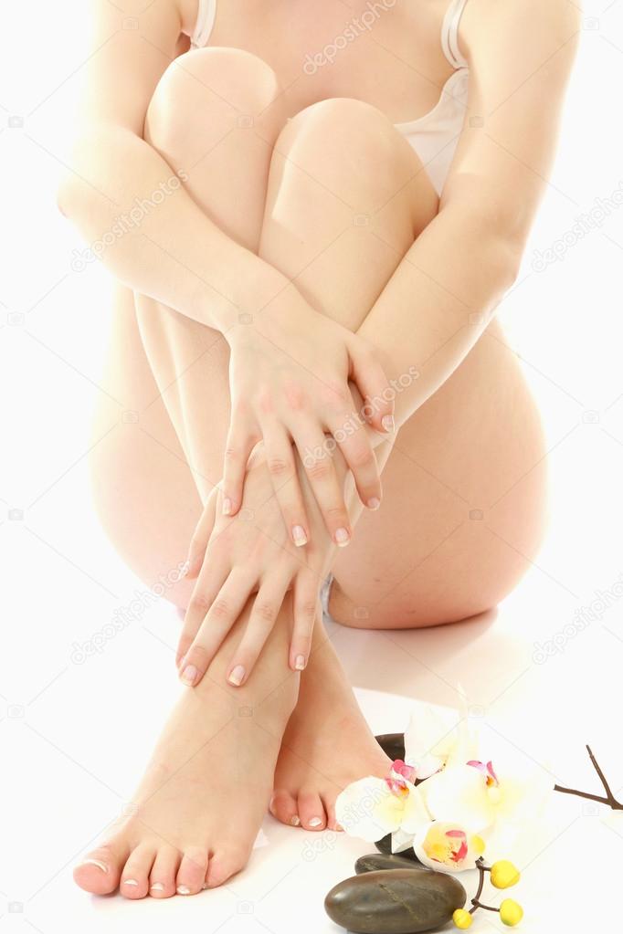 Female feet and flower. Isolated over white background
