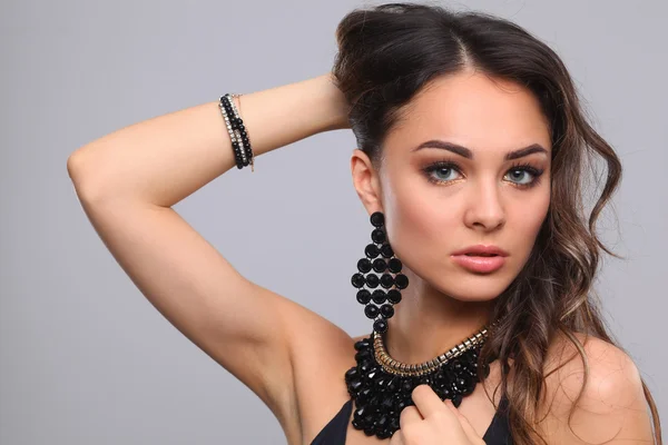 Portrait of a beautiful woman with necklace, isolated on grey background — Stock Photo, Image