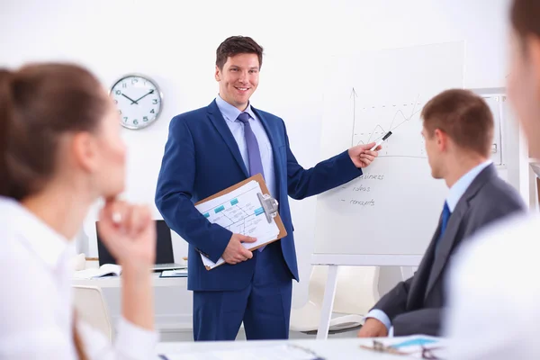 Uomo d'affari di successo in piedi con il suo personale in background in ufficio — Foto Stock