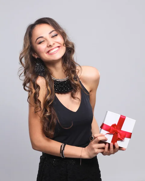 Young woman happy smile hold gift box in hands, isolated over grey background — Stock Photo, Image