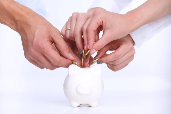 Putting coin into the piggy bank — Stock Photo, Image