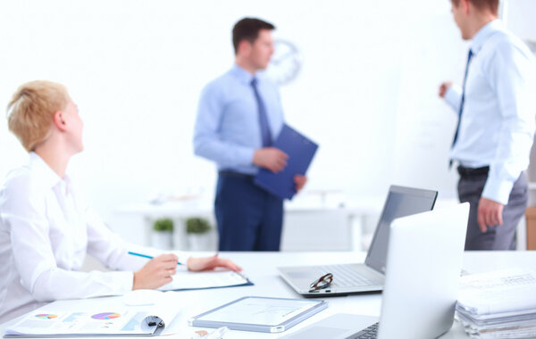 Business people sitting and discussing at business meeting, in office