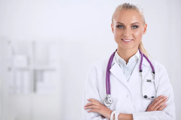 Retrato de una joven doctora con una bata blanca de pie en el hospital —  Fotos de Stock