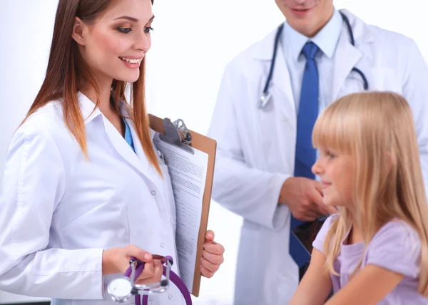 Female doctor examining child with stethoscope at surgery Stock Image