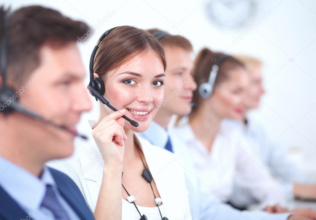 Attractive Smiling positive young businesspeople and colleagues in a call center office
